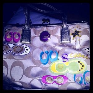 Coach purse with multi colored horseshoe imprint